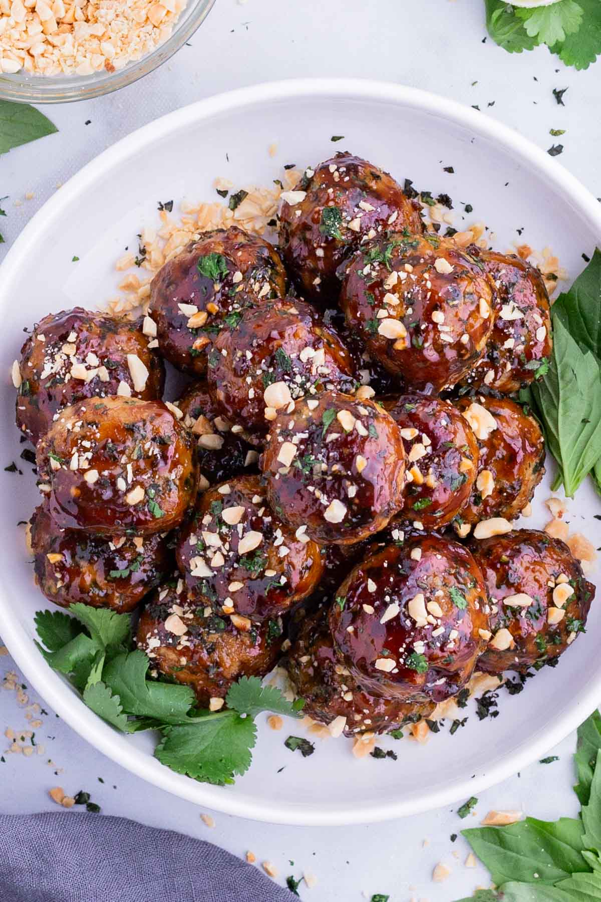 Sticky Thai Chicken Meatballs RECIPE served in a white bowl.