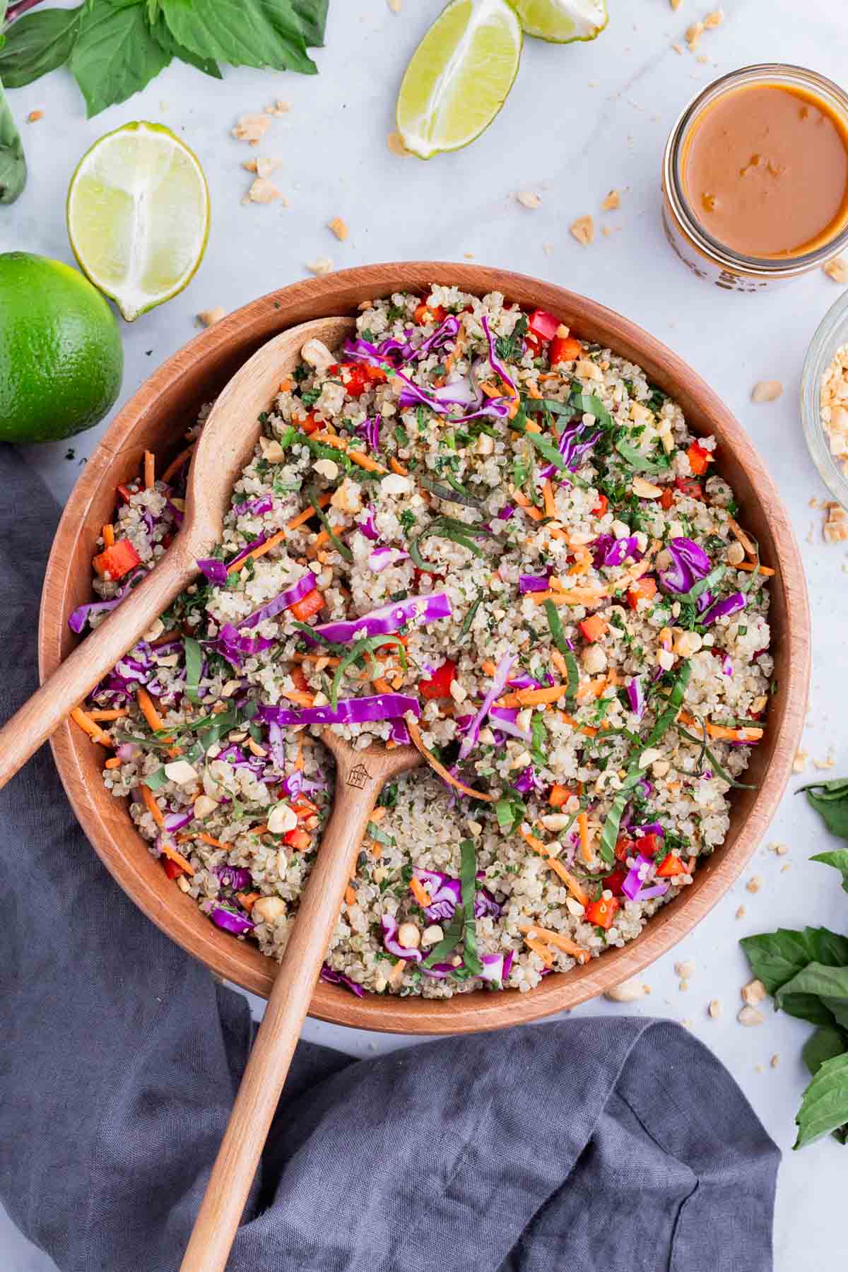 Wooden spoons are used to serve healthy quinoa salad.