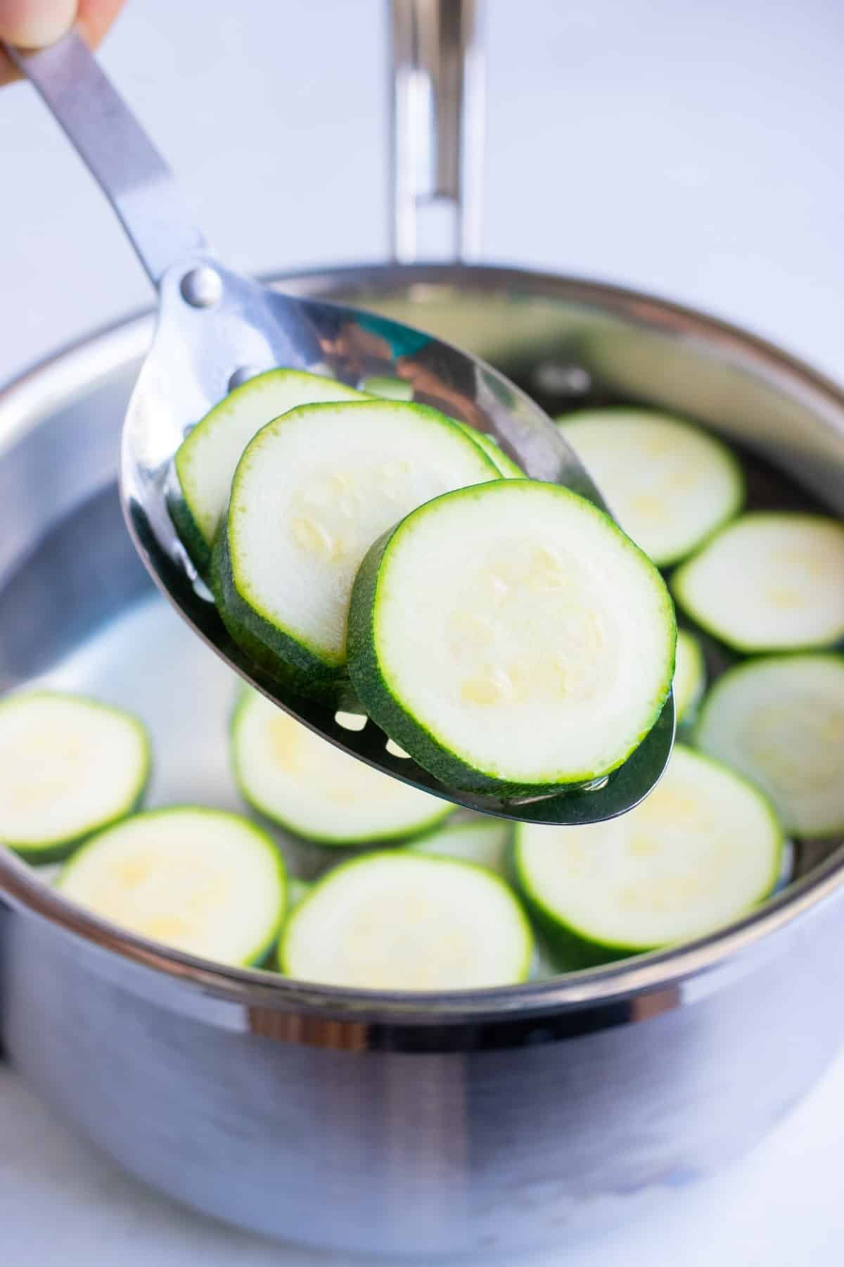Zucchini is quickly cooked in boiling water before blanching and freezing.