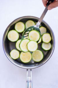 Zucchini is quickly cooked in boiling water before blanching and freezing.