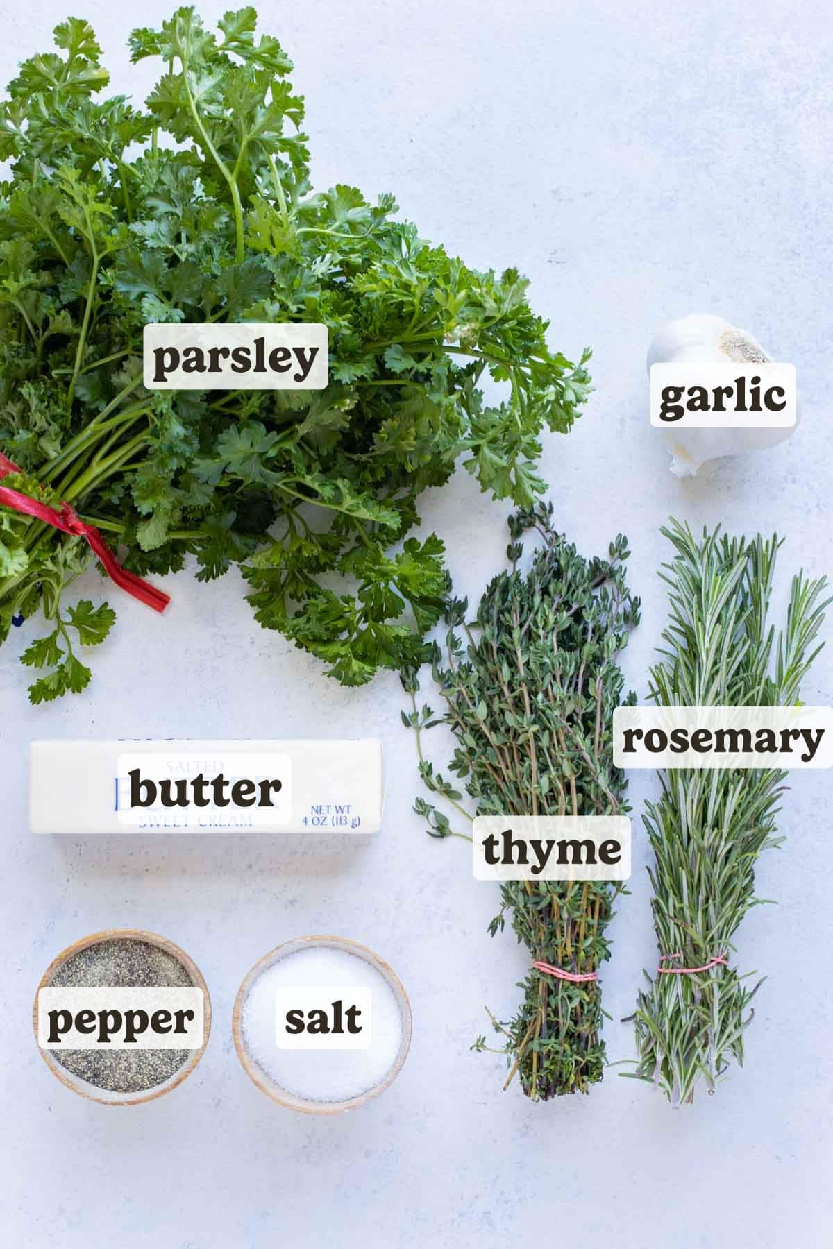 Butter, rosemary, thyme, parsley, garlic, salt, and pepper are the ingredients for this garlic herb butter recipe.