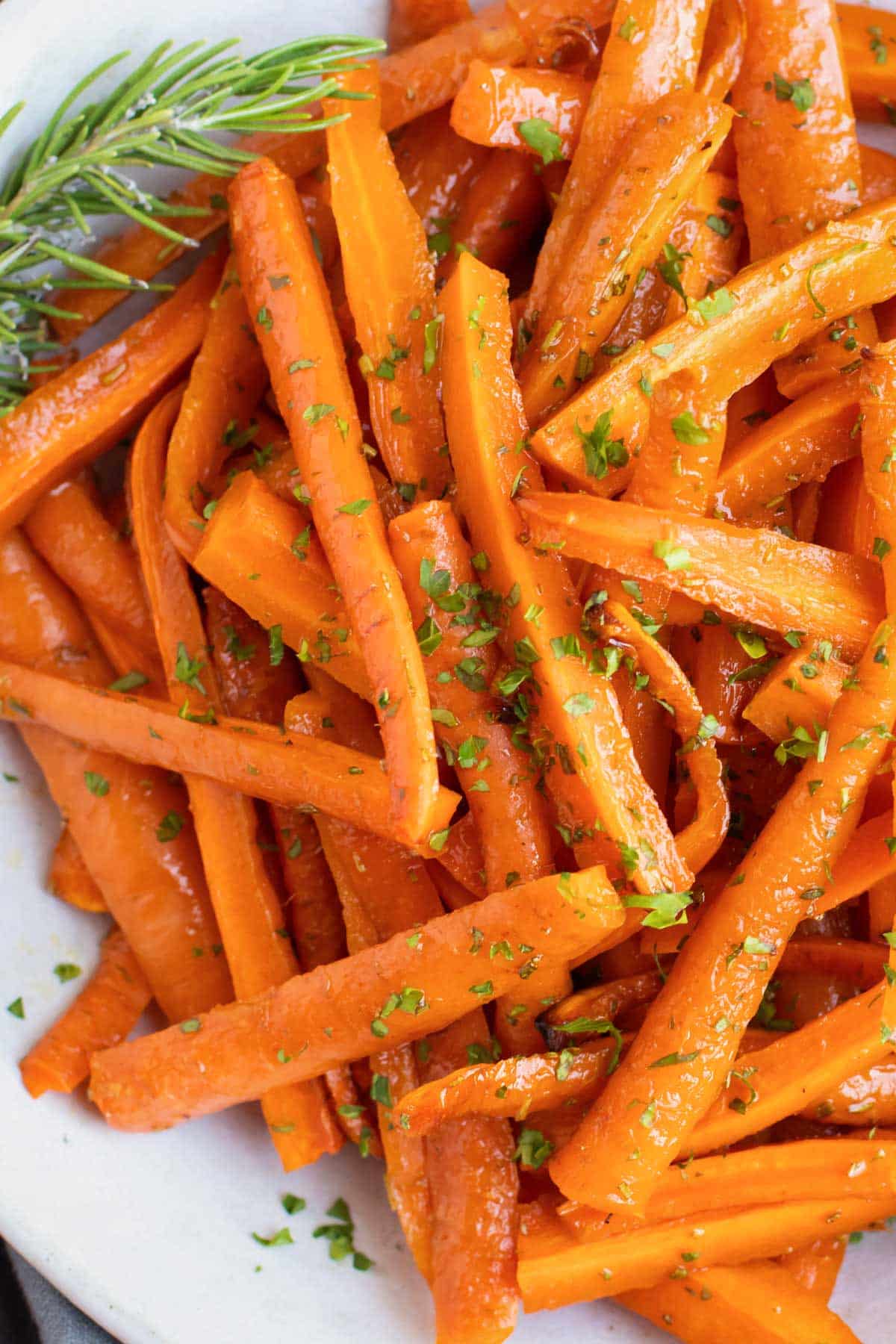 Herb Roasted Carrots RECIPE served on a white platter.