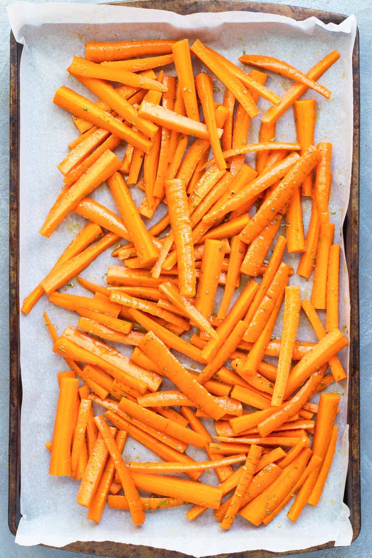 Honey roasted carrots on a baking sheet lined with parchment paper.