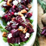 A tray filled with roasted beets, goat cheese, and pecans for an easy holiday side dish.