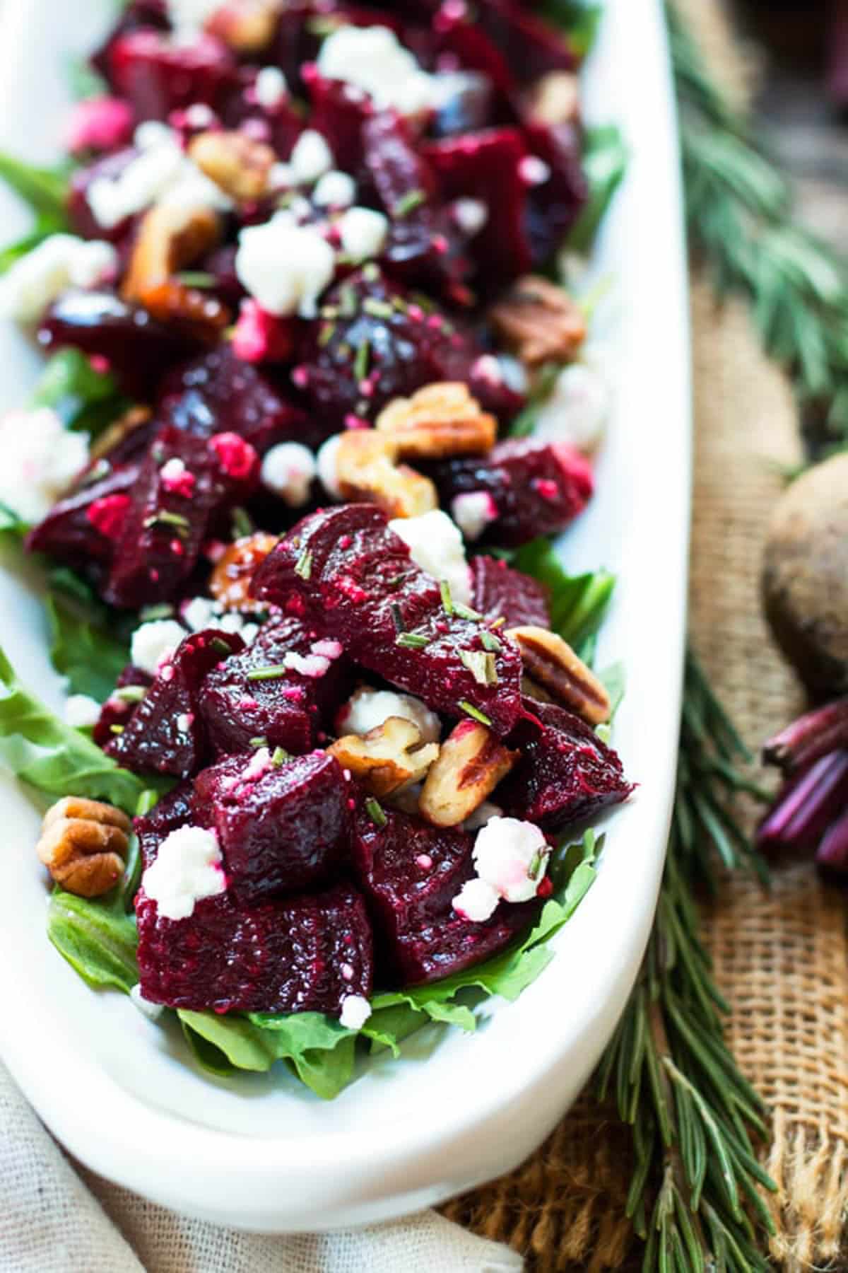 A tray filled with roasted beets, goat cheese, and pecans for an easy holiday side dish.