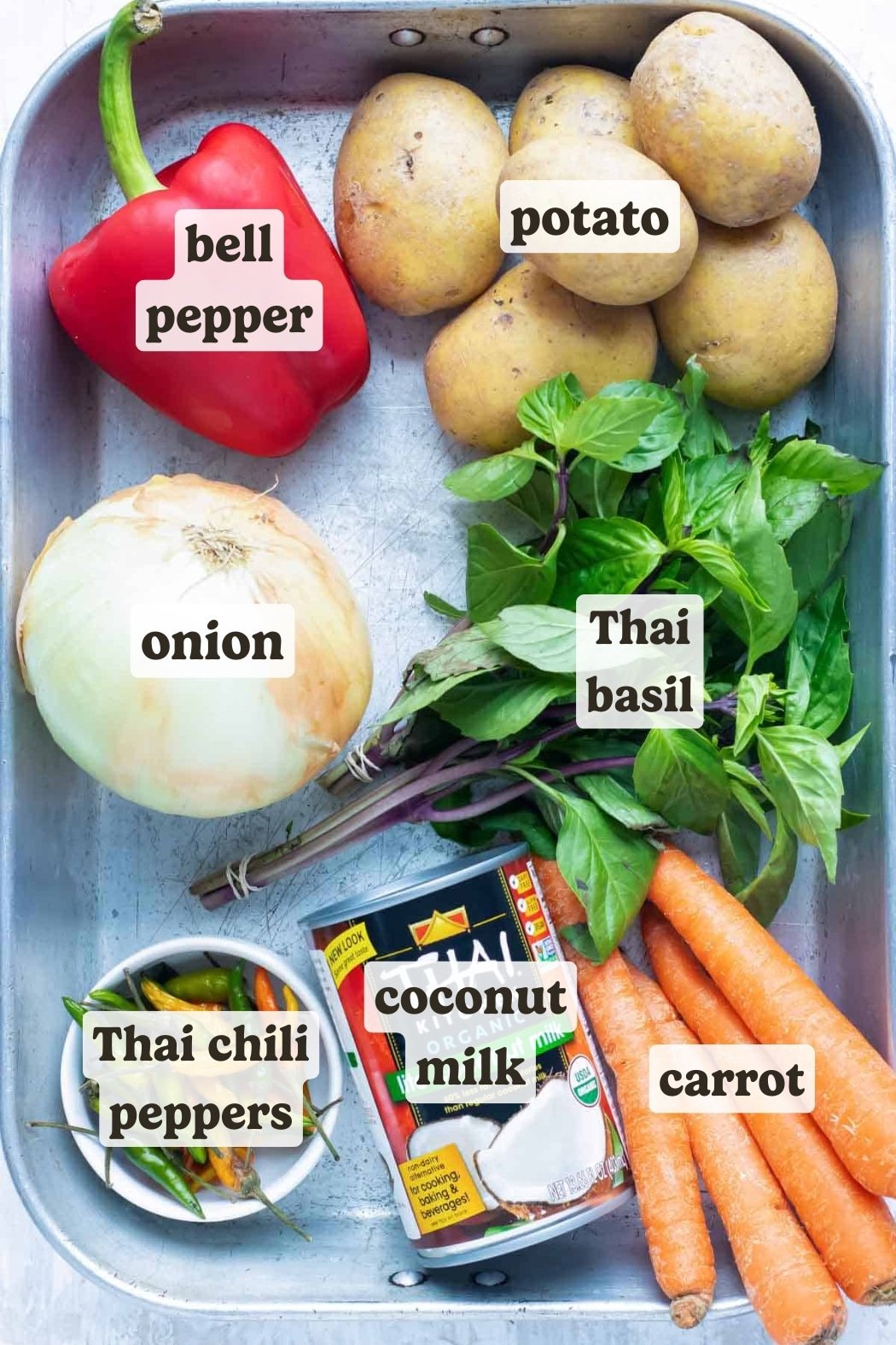 Potatoes, carrots, coconut milk, and basil are some of the ingredients for a Thai yellow curry recipe.