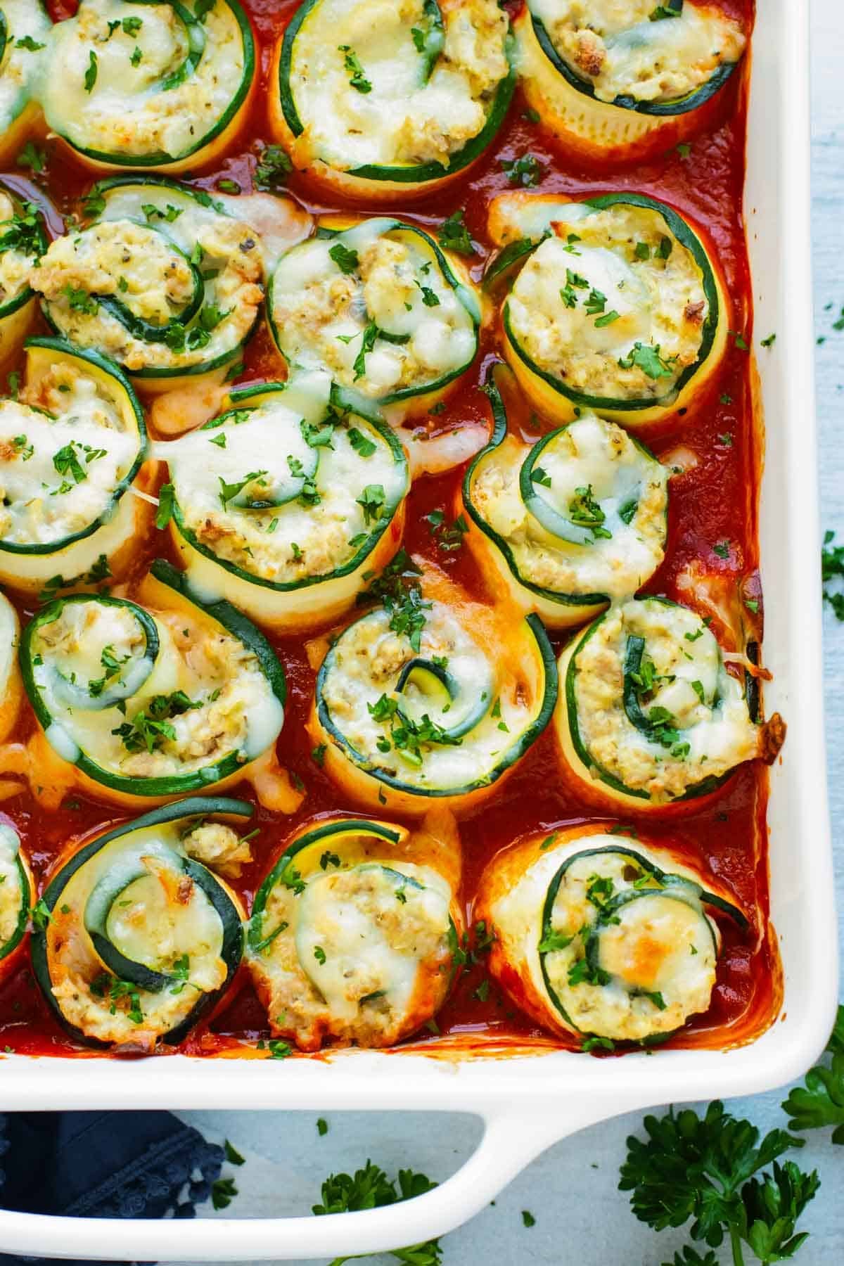 Zucchini Lasagna Roll-Ups RECIPE served in a white casserole dish.