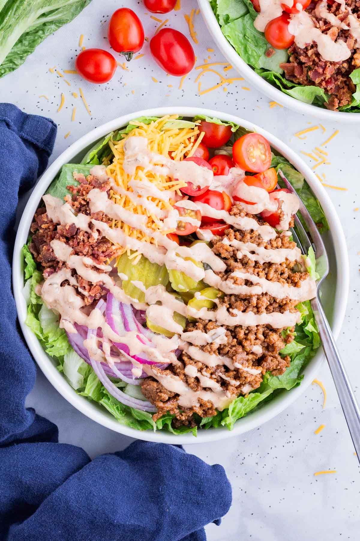 Burger Bowls with Secret Sauce RECIPE served in a white bowl with a spoon.