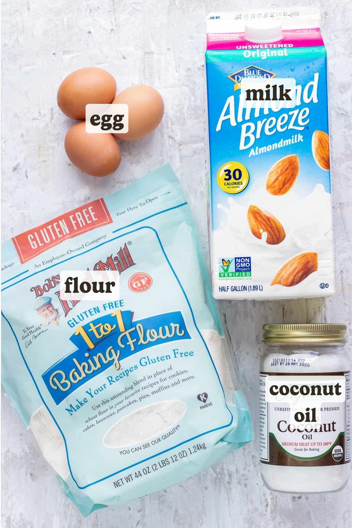 Almond milk, coconut oil, gluten-free flour, and three eggs as the ingredients for an easy pancake recipe.