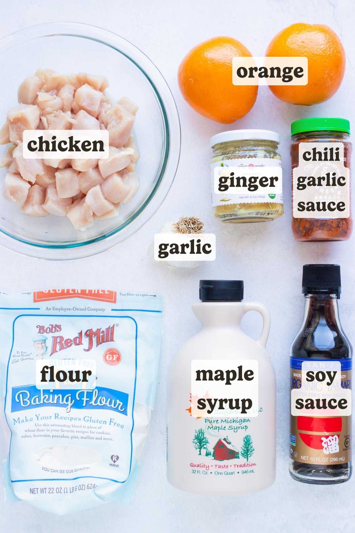 Chicken breasts, oranges, Tamari sauce, and flour as the ingredients needed for a gluten free orange chicken recipe.