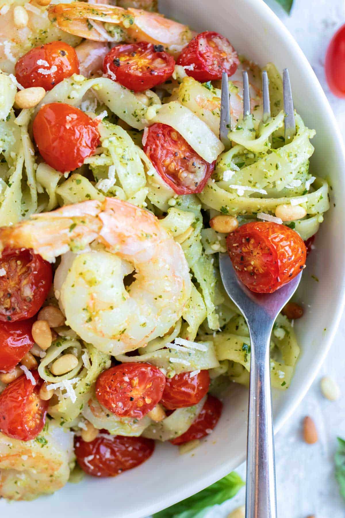 Shrimp Pesto Pasta RECIPE served in a white bowl and a fork.