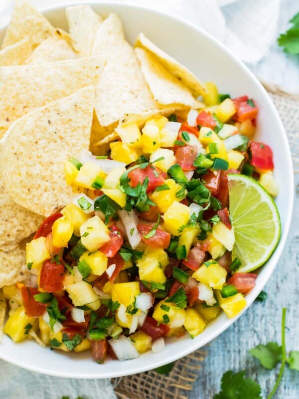Gluten-free Pineapple Pico de Gallo with tortilla chips in a bowl for a healthy snack.