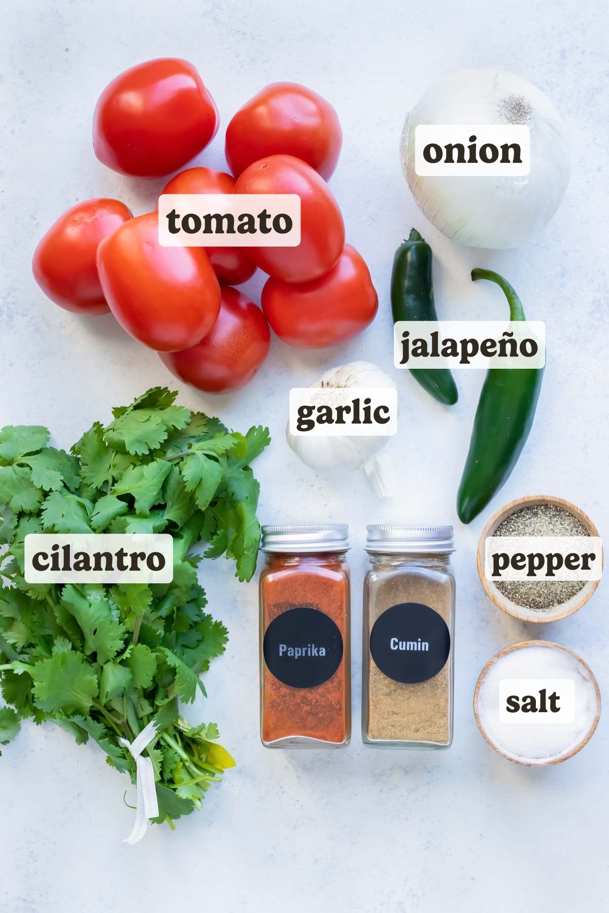 Tomatoes, jalapeño peppers, garlic, cilantro, onion, and seasonings are the ingredients for this roasted salsa recipe.