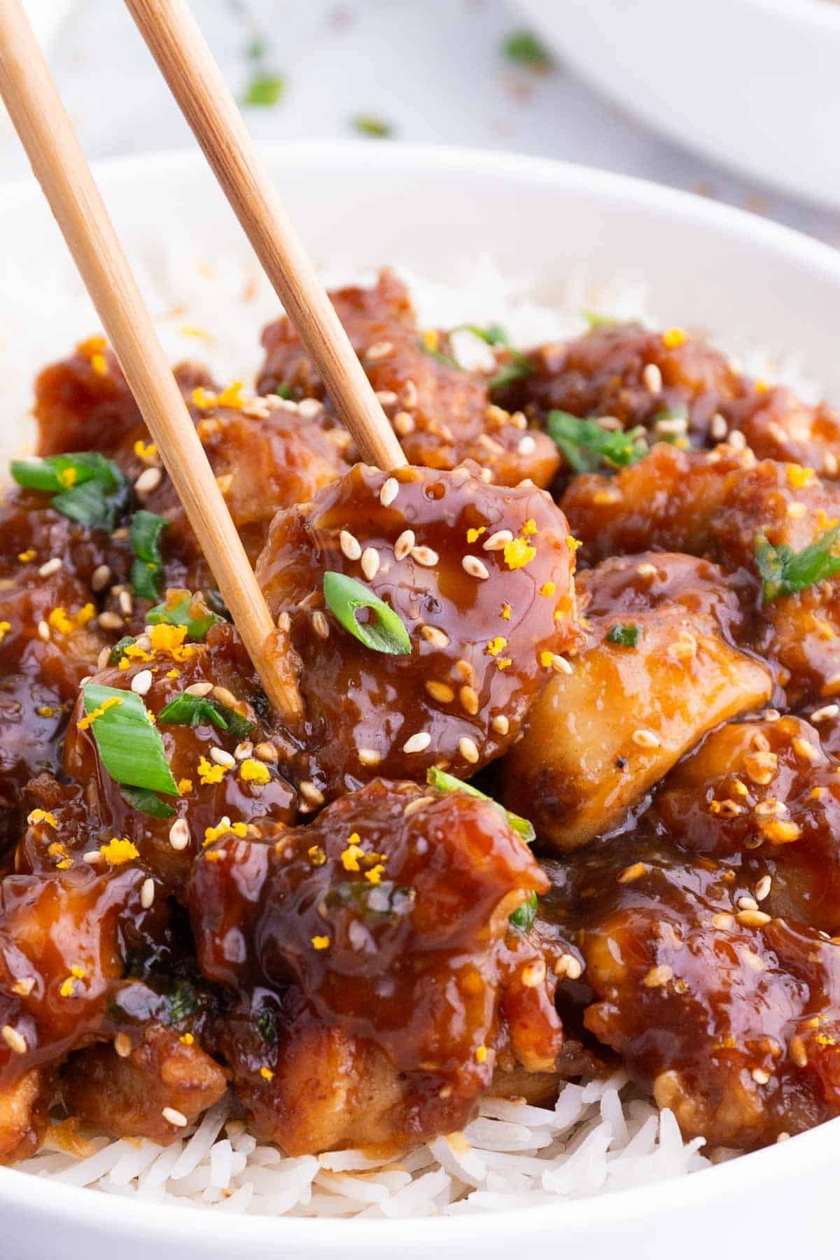 Gluten-Free Orange Chicken RECIPE served over rice and with chopsticks.