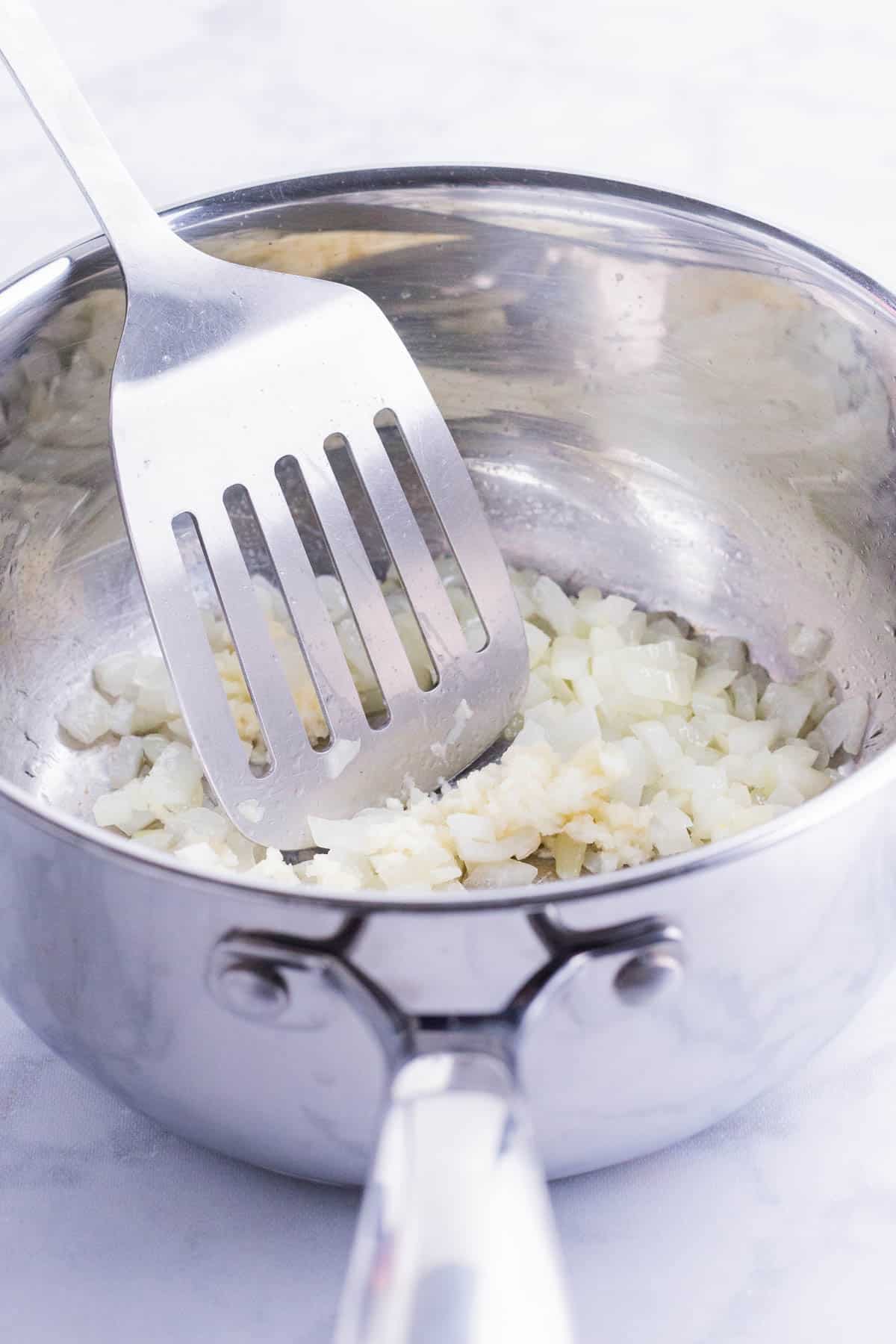 Garlic is added to the sauteed onion.