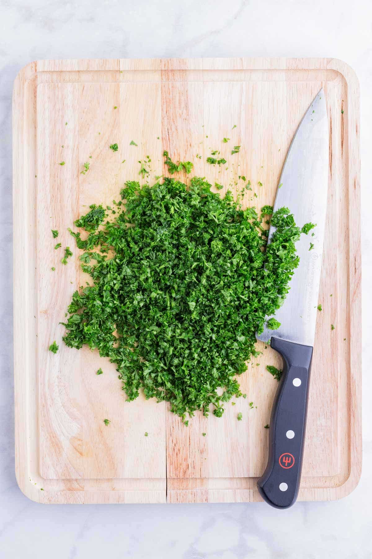 Parsley is chopped into small pieces.