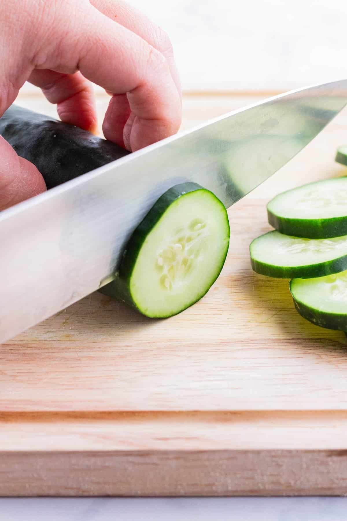 A cucumber is cut into thin slices.