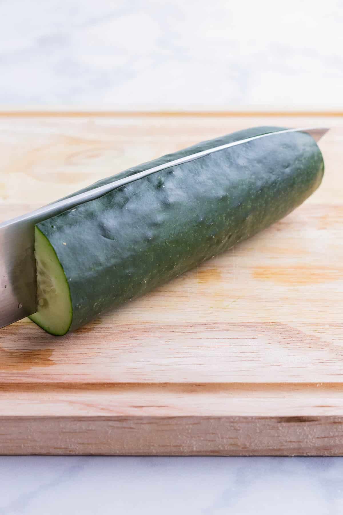 A cucumber is cut in half lengthwise.