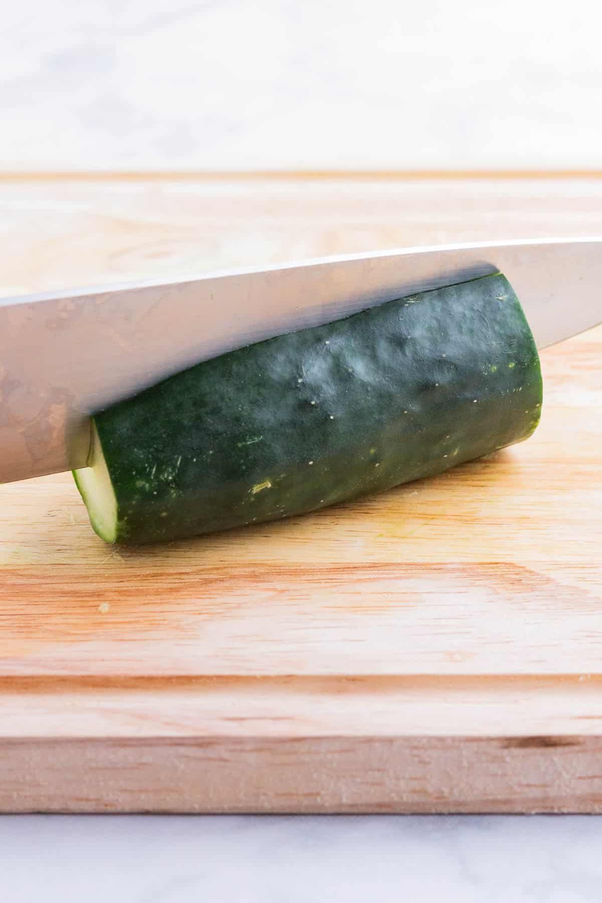 A cucumber is cut in half lengthwise.
