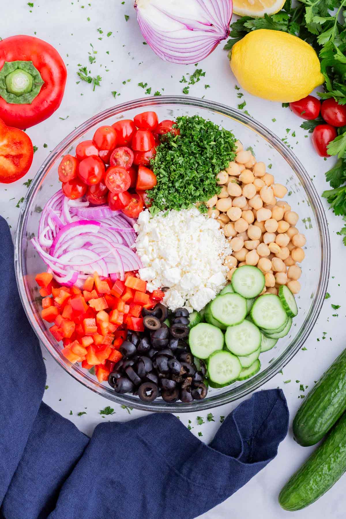 The salad ingredients are added to a large bowl.