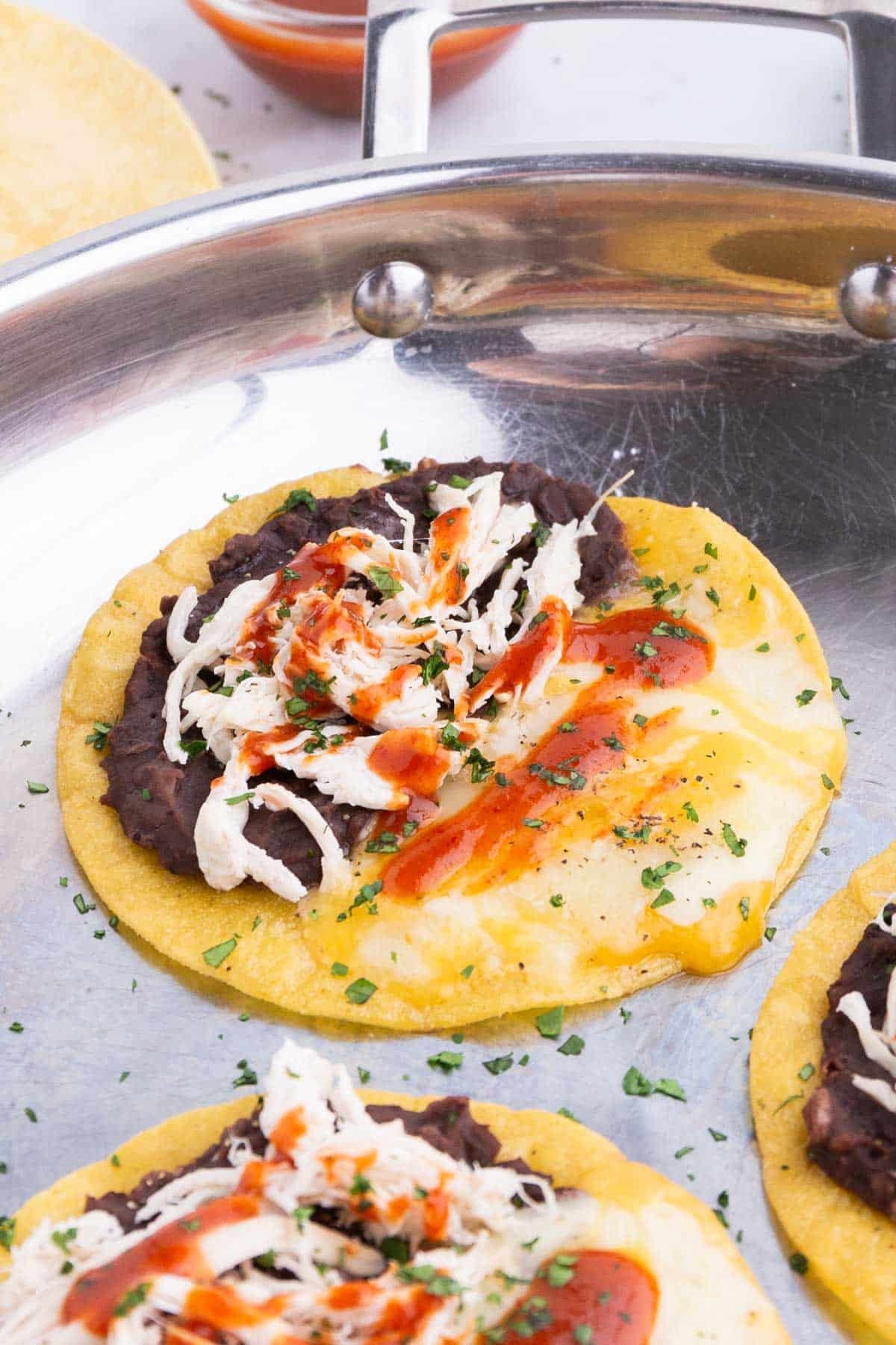 You can add chicken, Sriracha, and cilantro to these quesadillas.