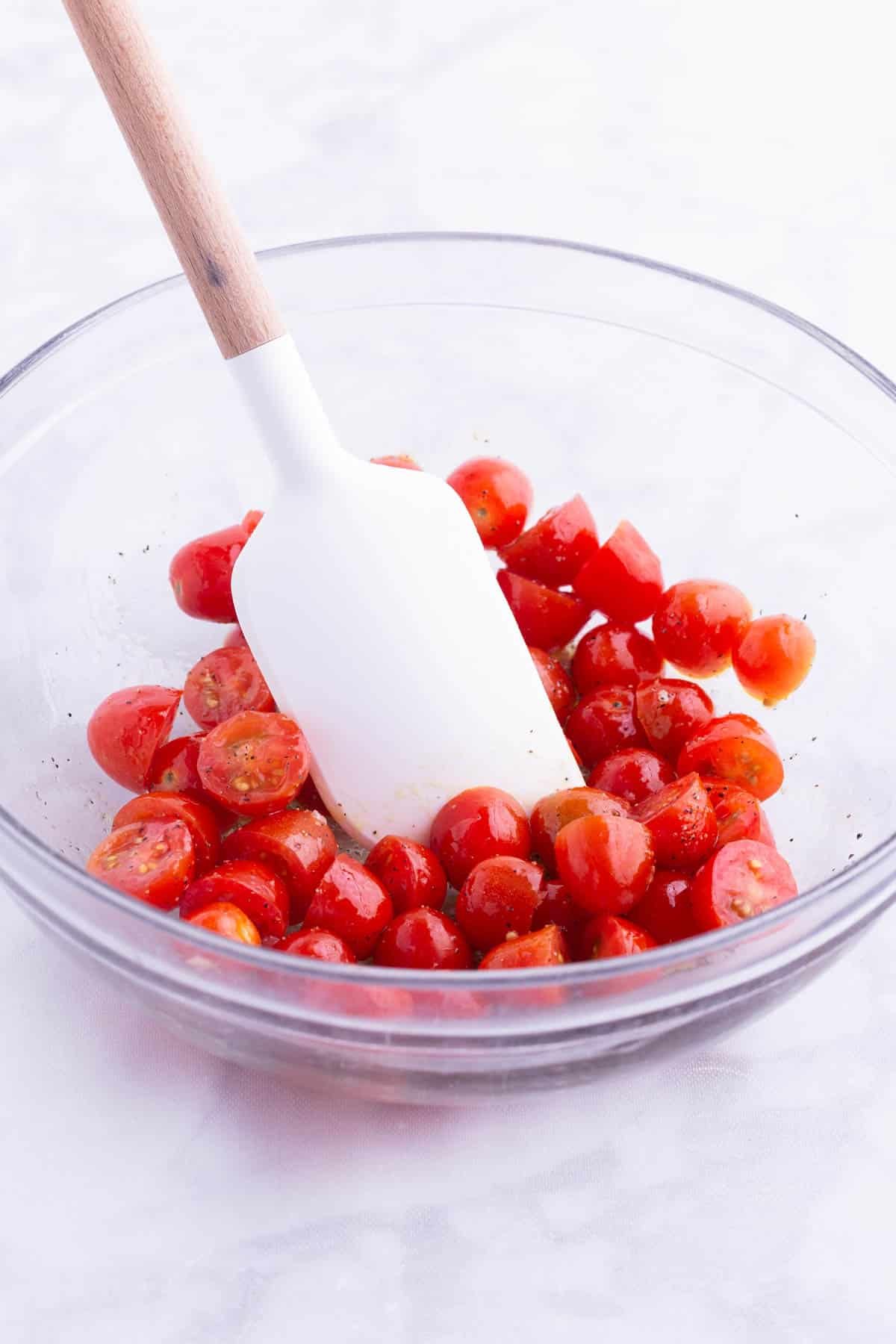 Cherry tomatoes are tossed in a garlic sauce.