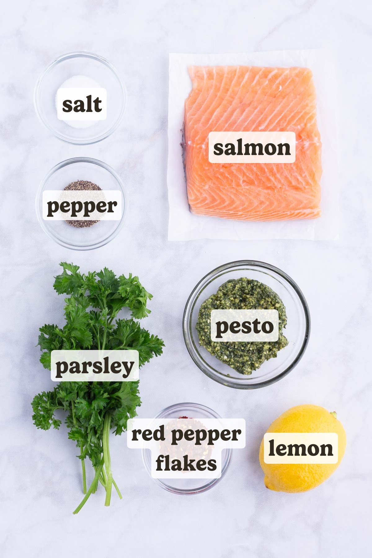 Salmon, pesto, lemon, and seasonings are the main ingredients of this baked pesto salmon dish.
