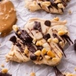 Pieces of chunky monkey frozen yogurt bark are spread on a tray.
