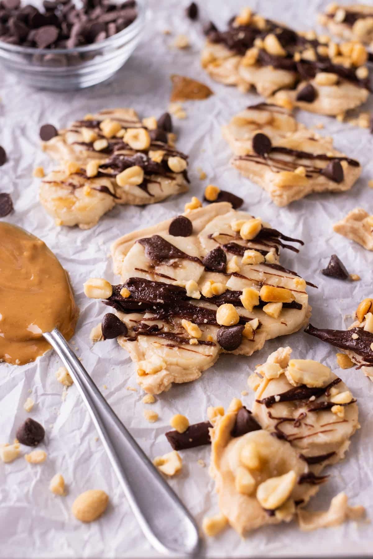 Pieces of chunky monkey frozen yogurt bark are spread on a tray.