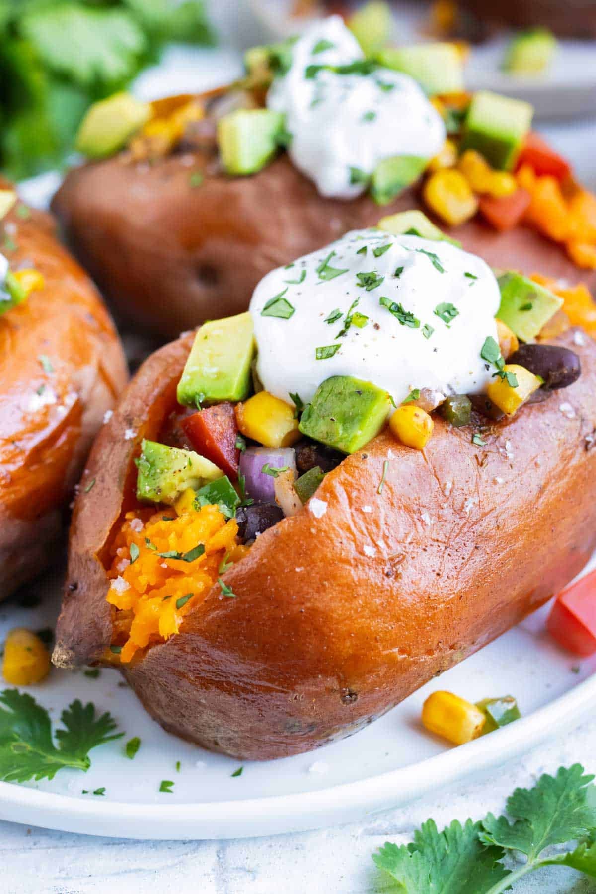 Baked sweet potatoes are filled with a Mexican mixture.