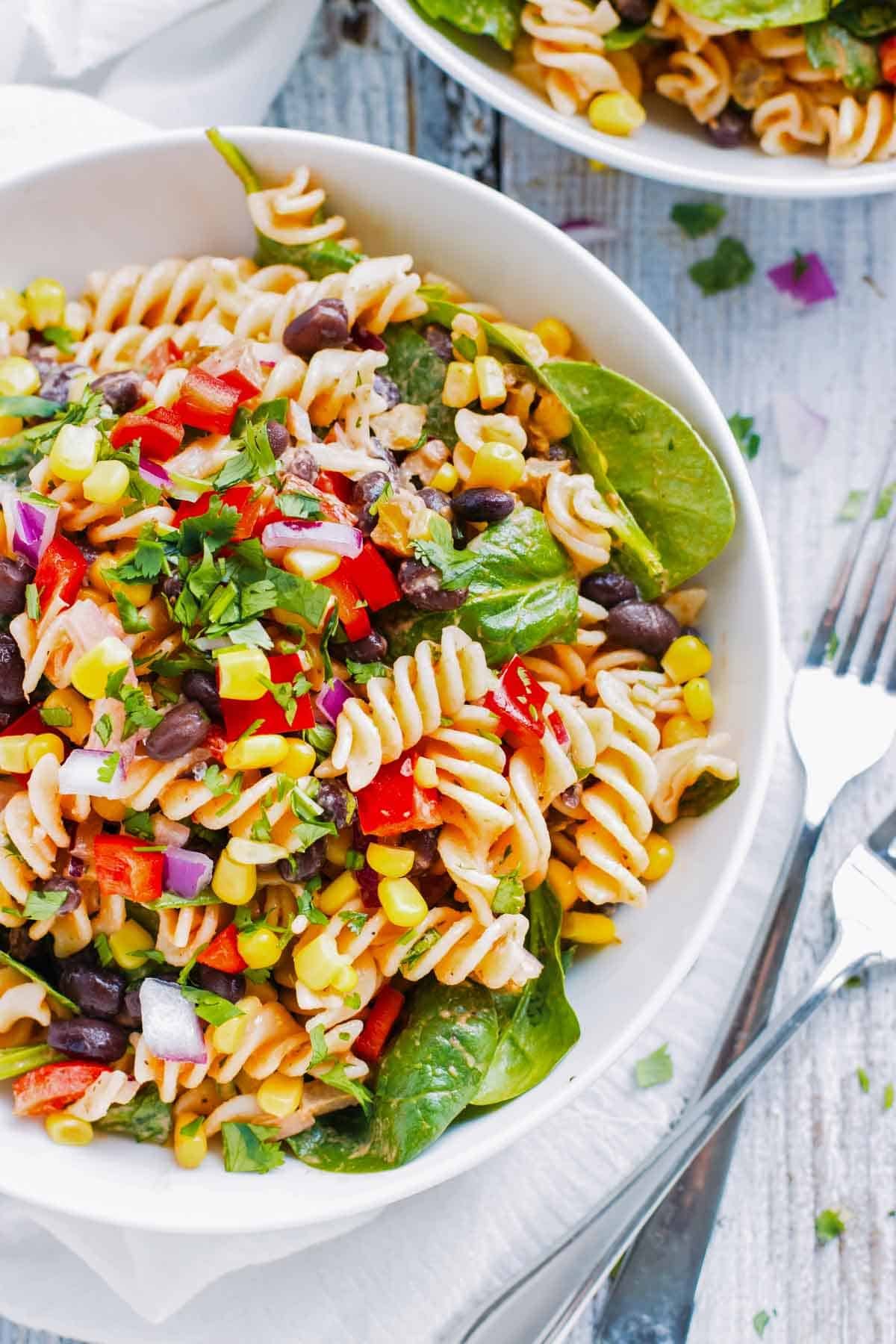 Mexican Pasta Salad with Salsa Ranch RECIPE served in a white glass bowl.