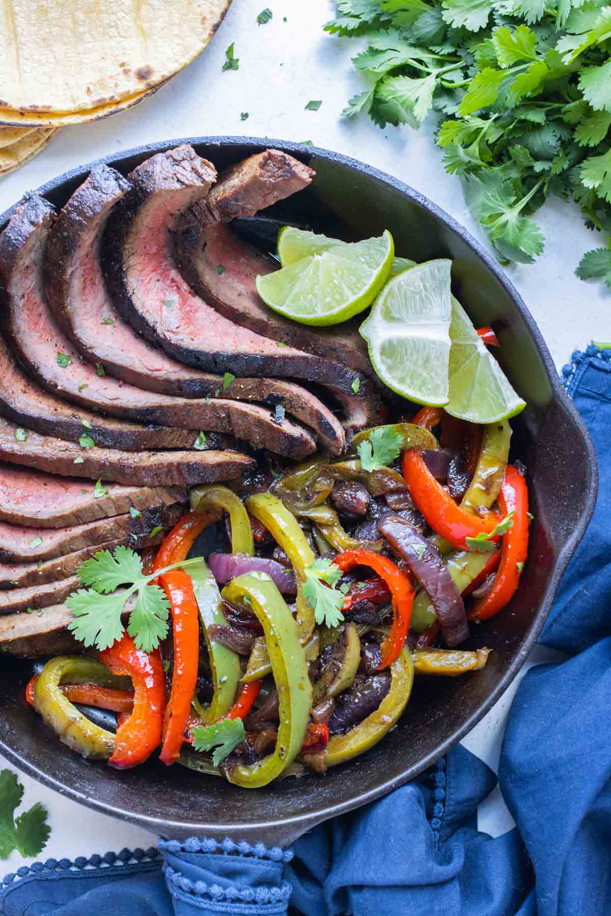 The steak fajitas and vegetables are served in a bowl.