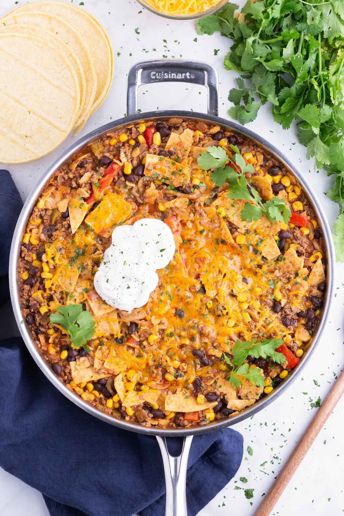 This beef taco skillet is topped with cheese and sour cream.