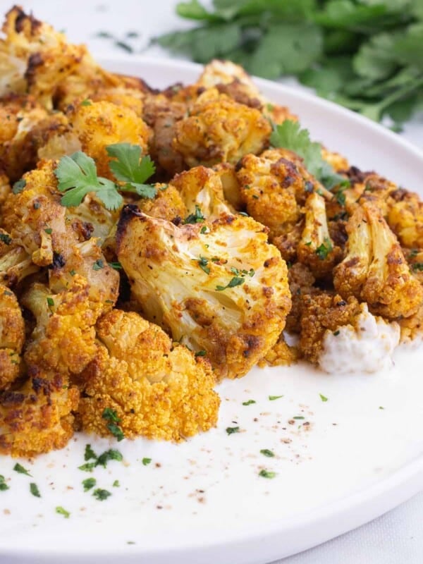 Cauliflower is seasoned with curry spices and roasted in the oven.