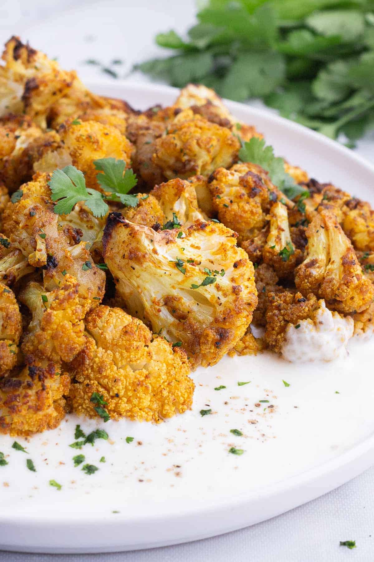Cauliflower is seasoned with curry spices and roasted in the oven.