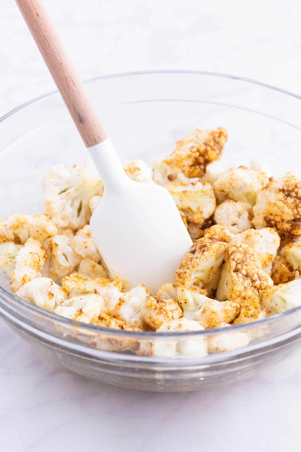 Cauliflower is seasoned with spices.