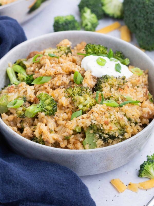 This cheesy broccoli and rice recipe is served up in a white bowl.