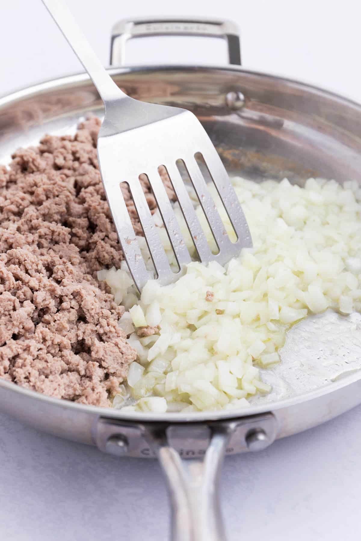 Onion is also cooked in a skillet.