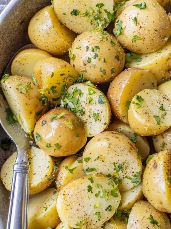 A spoon in a bowl with perfectly boiled potatoes