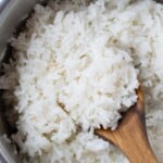 A wooden spoon serves up coconut milk rice.