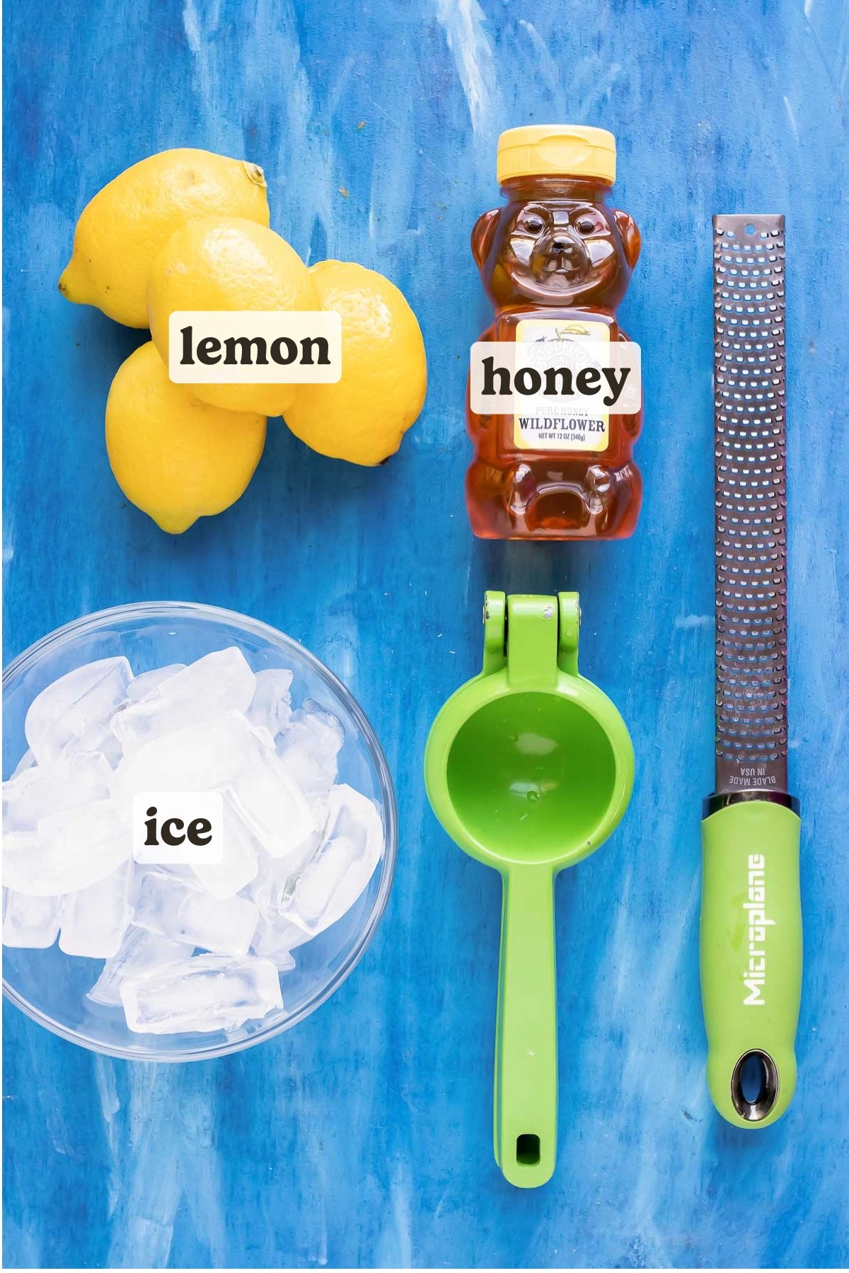 Lemons, honey, and ice as the ingredients for an easy frozen lemonade recipe.