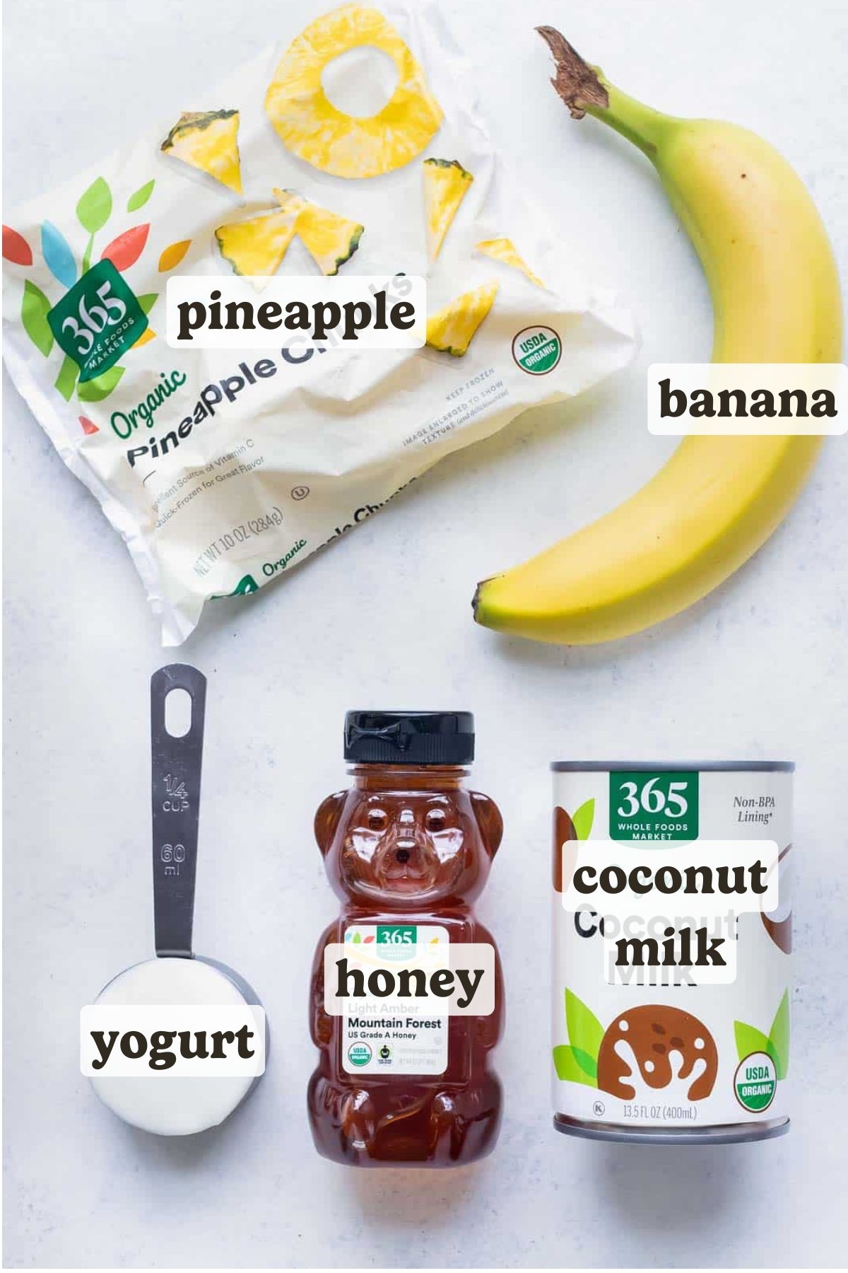Frozen pineapple, banana, coconut milk, yogurt, and honey are the ingredients for this recipe.