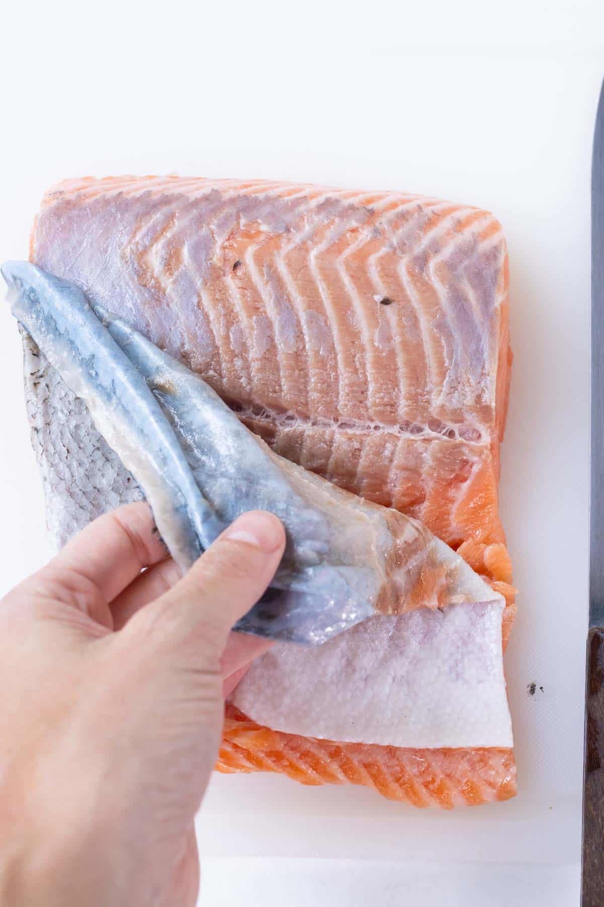 The skin is removed from the salmon.
