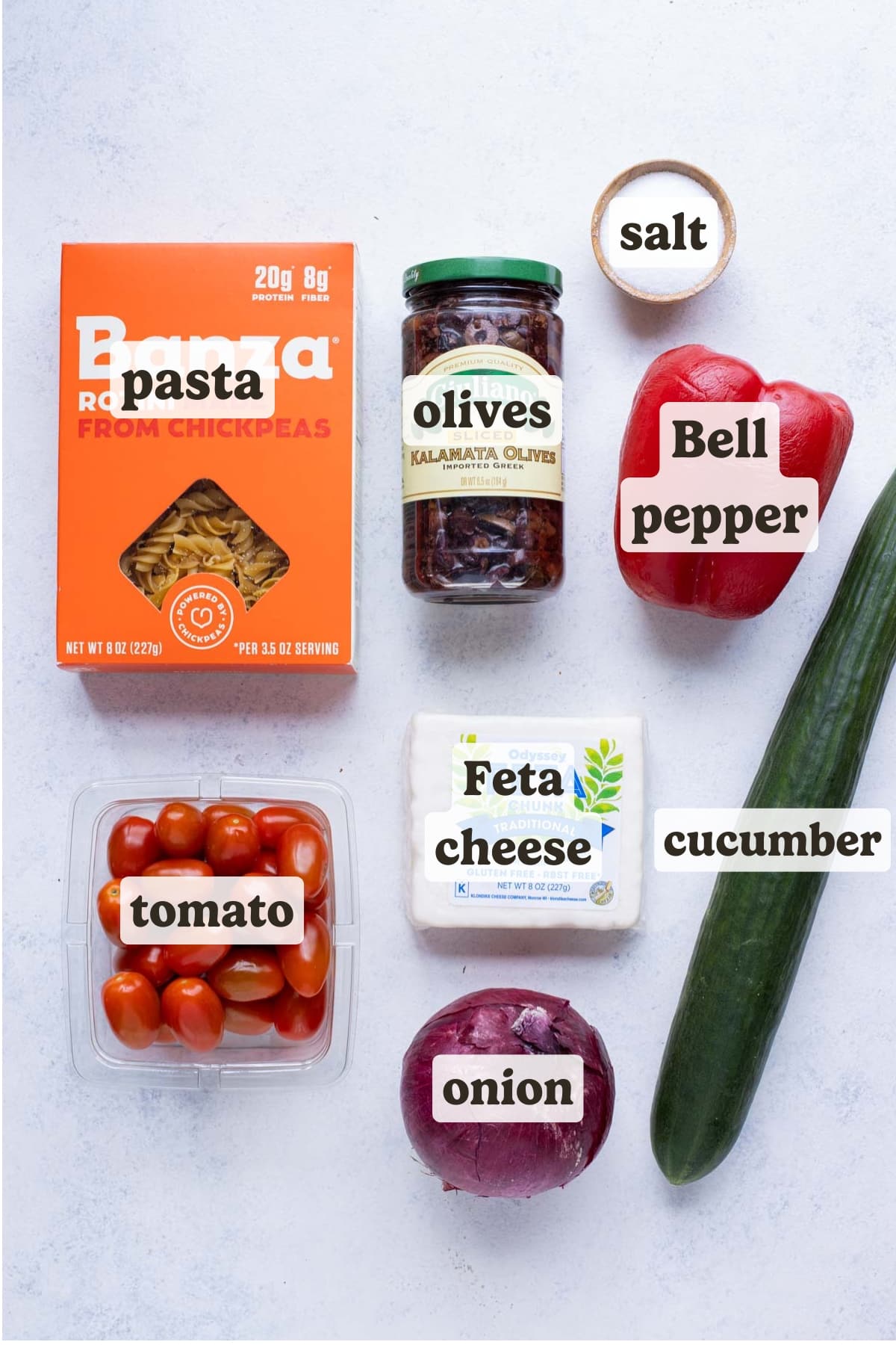 Pasta, roma tomatoes, feta cheese, olives, bell peppers, cucumbers, and red onions are the ingredients in this Greek pasta salad recipe.
