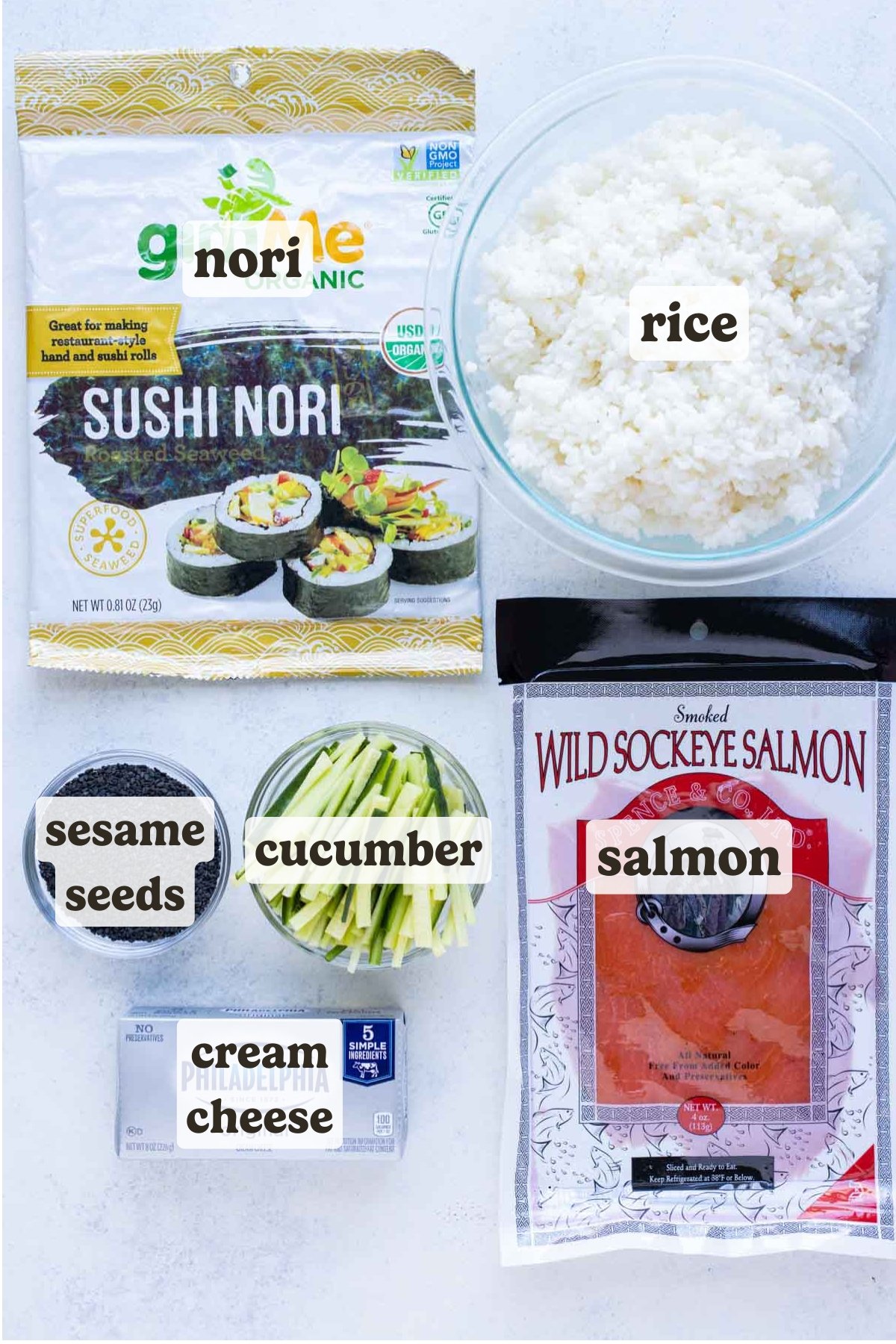 Smoked salmon, rice, nori seaweed, cucumber, cream cheese, sesame seeds are the ingredients for this recipe.