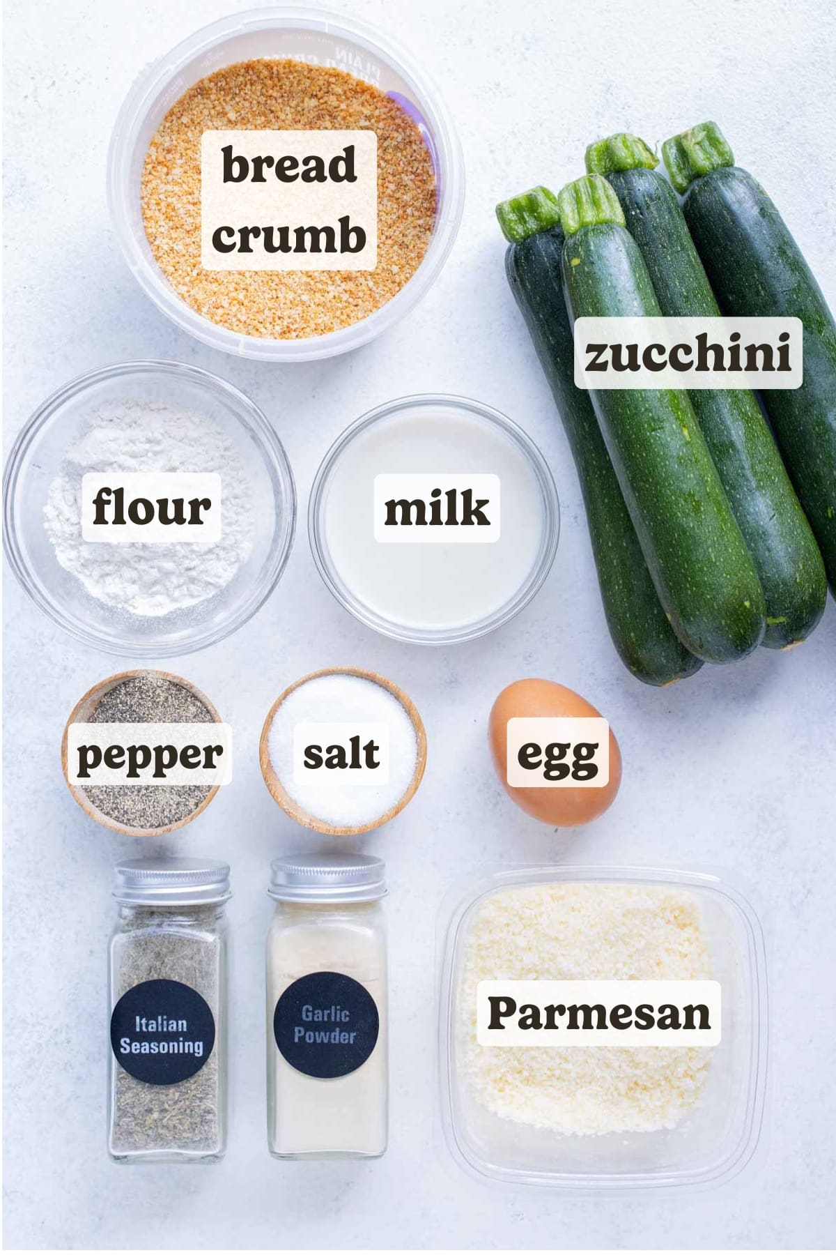 Zucchini, flour, breadcrumbs, egg, flour, and seasonings to make zucchini fries.