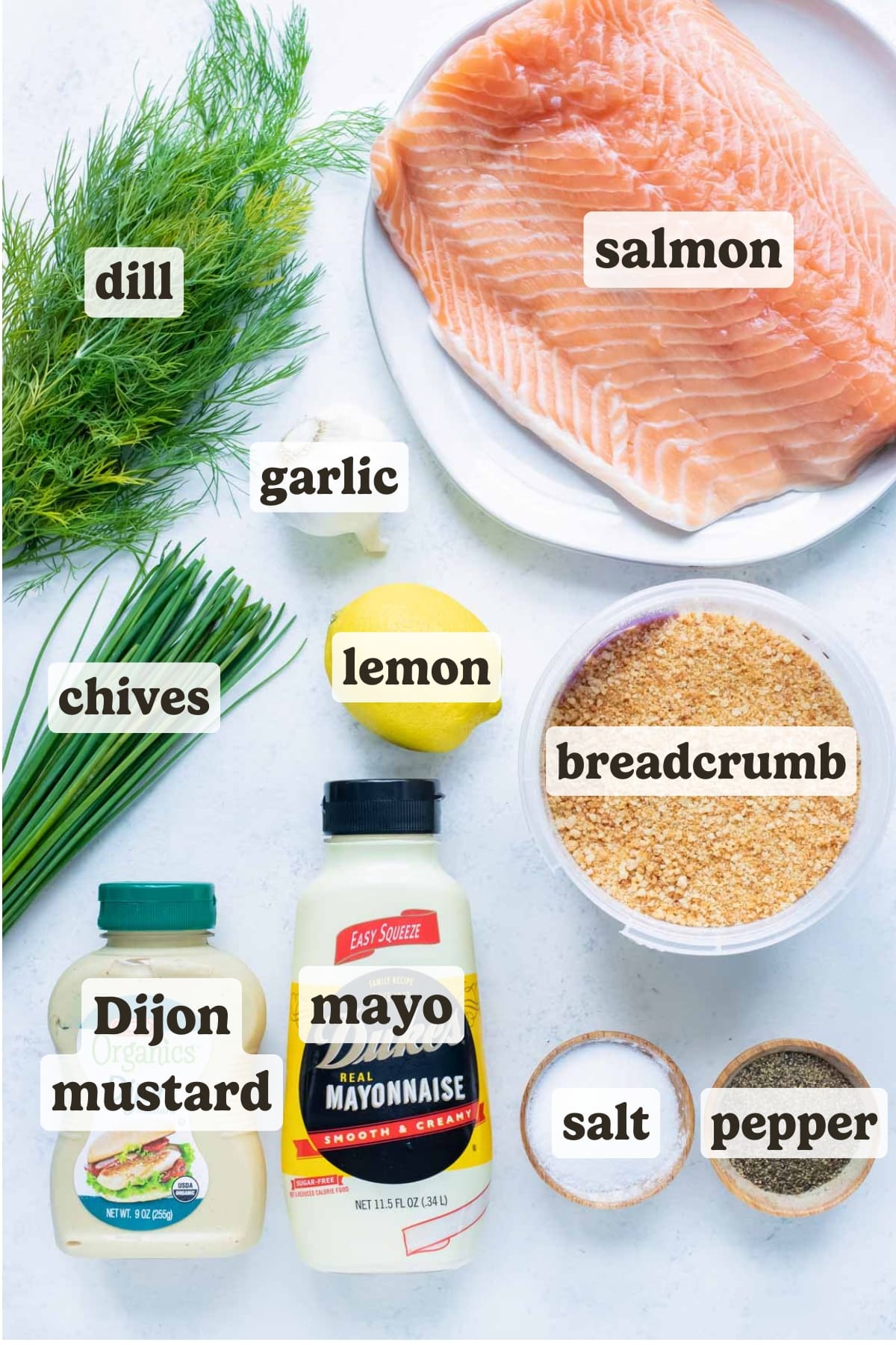 Mayonnaise, salmon, dill, chives, mustard, lemon, and breadcrumbs to make salmon burgers.
