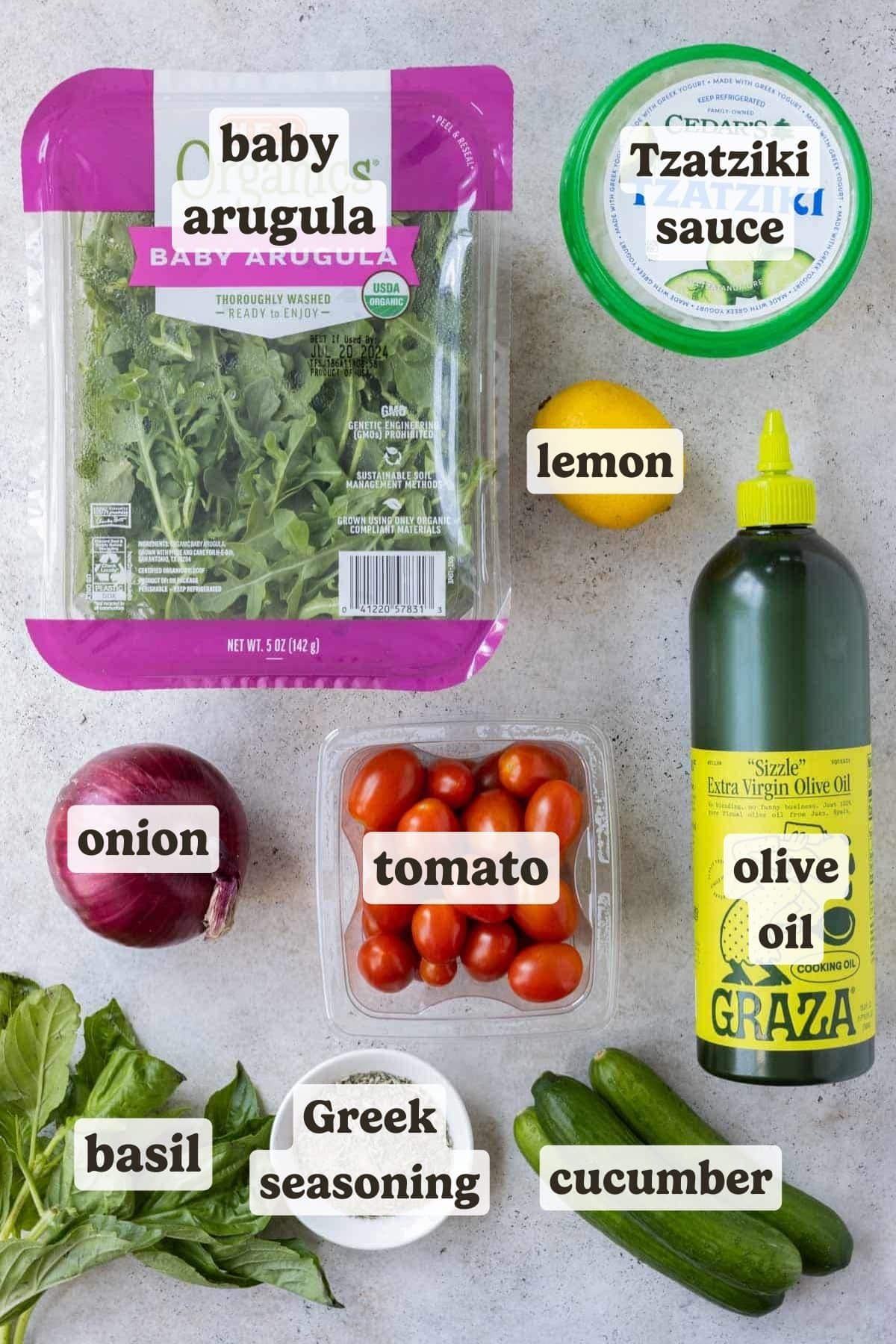 Arugula, Tzatziki sauce, tomatoes, onion, and cucumbers are some of the main ingredients for these Greek Chicken Tacos.