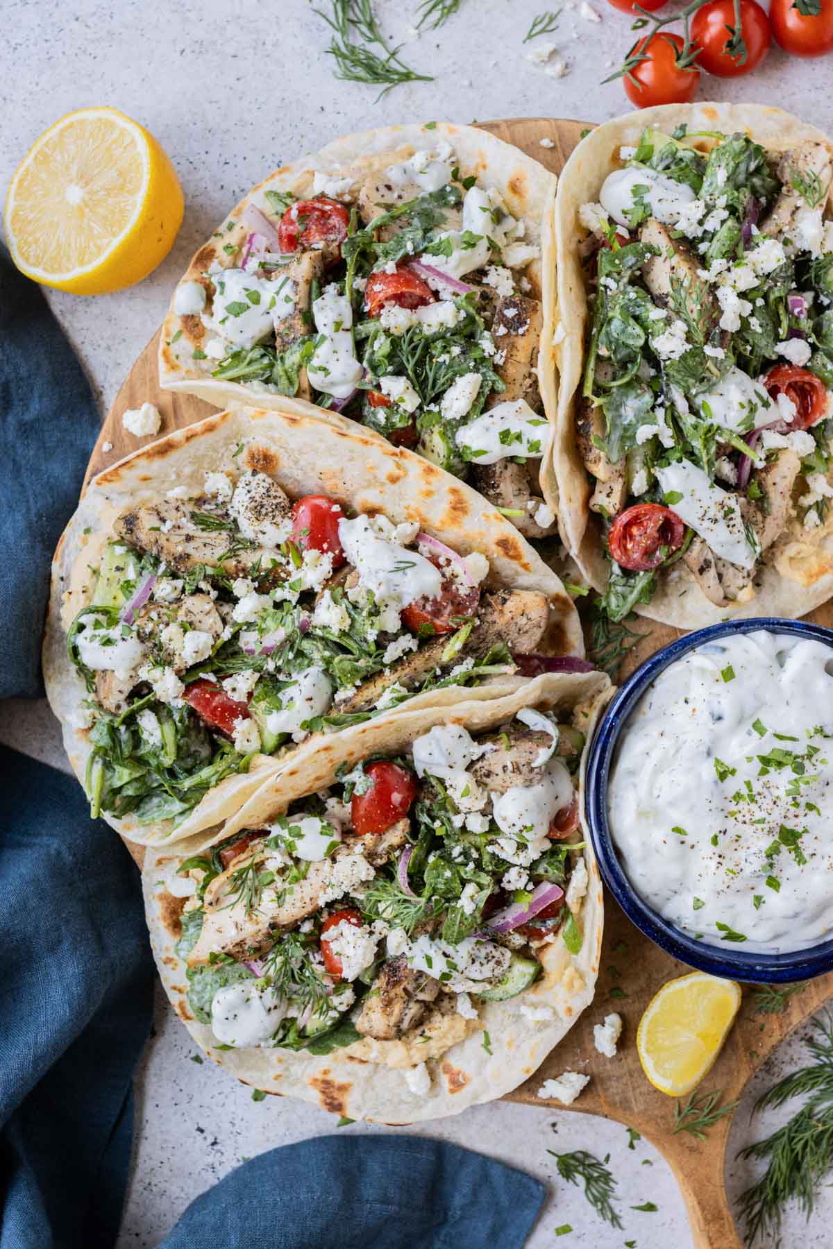 Greek chicken tacos, with fresh salad and Tzatziki sauce are served for a weeknight dinner.