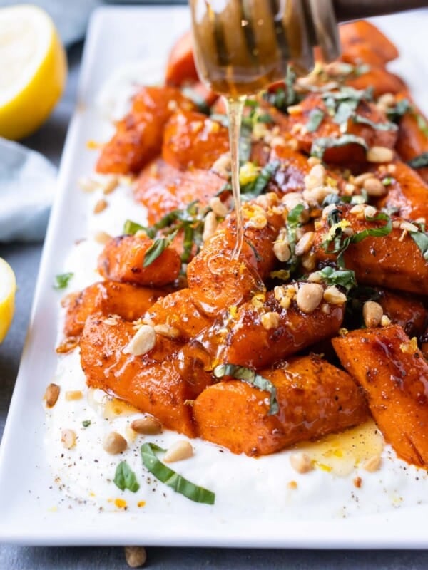 Hot honey is drizzled over spiced roasted carrots with a lemon Greek yogurt sauce.